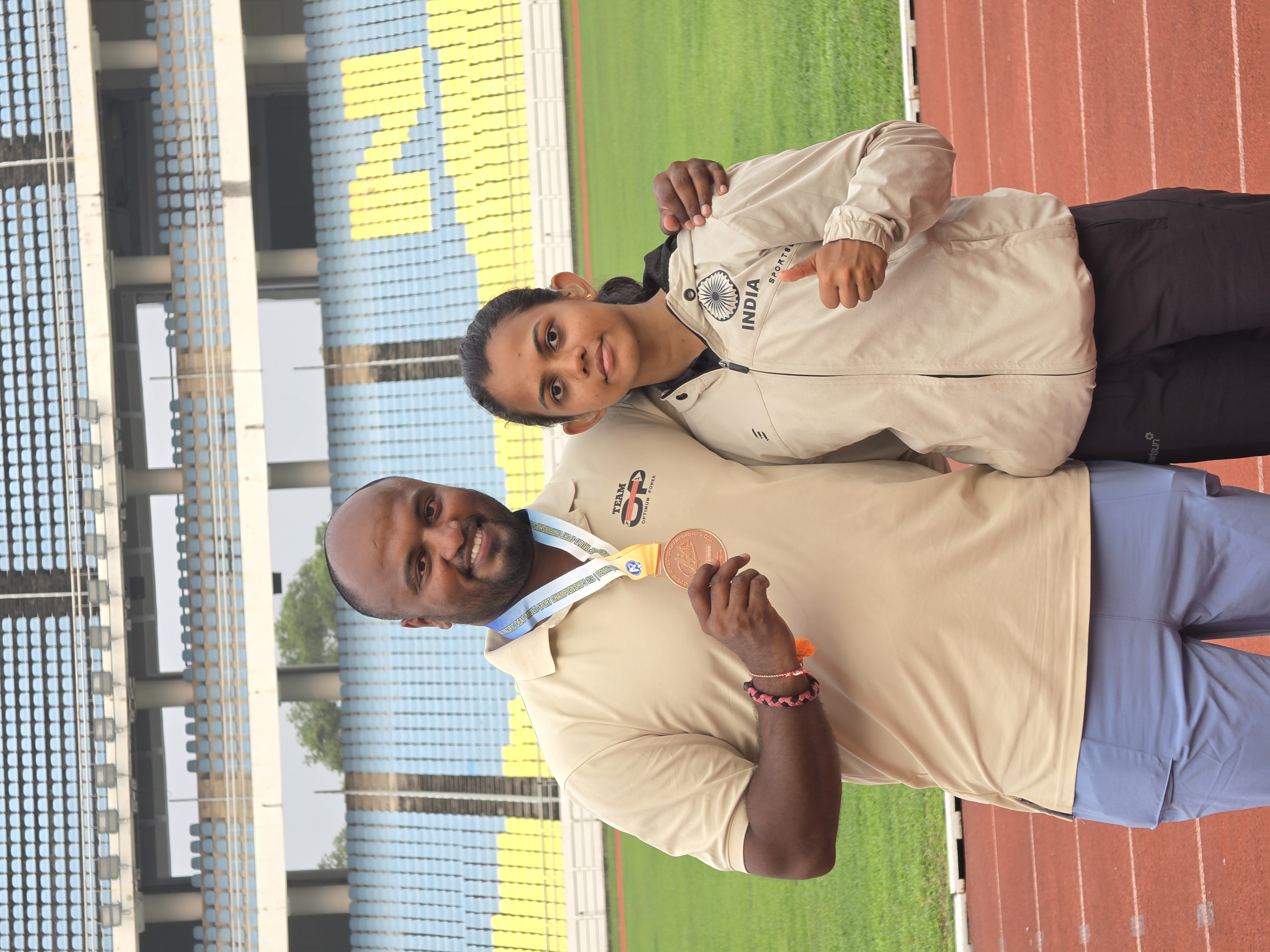Rishitha and coach Radesh celebrating with the bronze relay medal