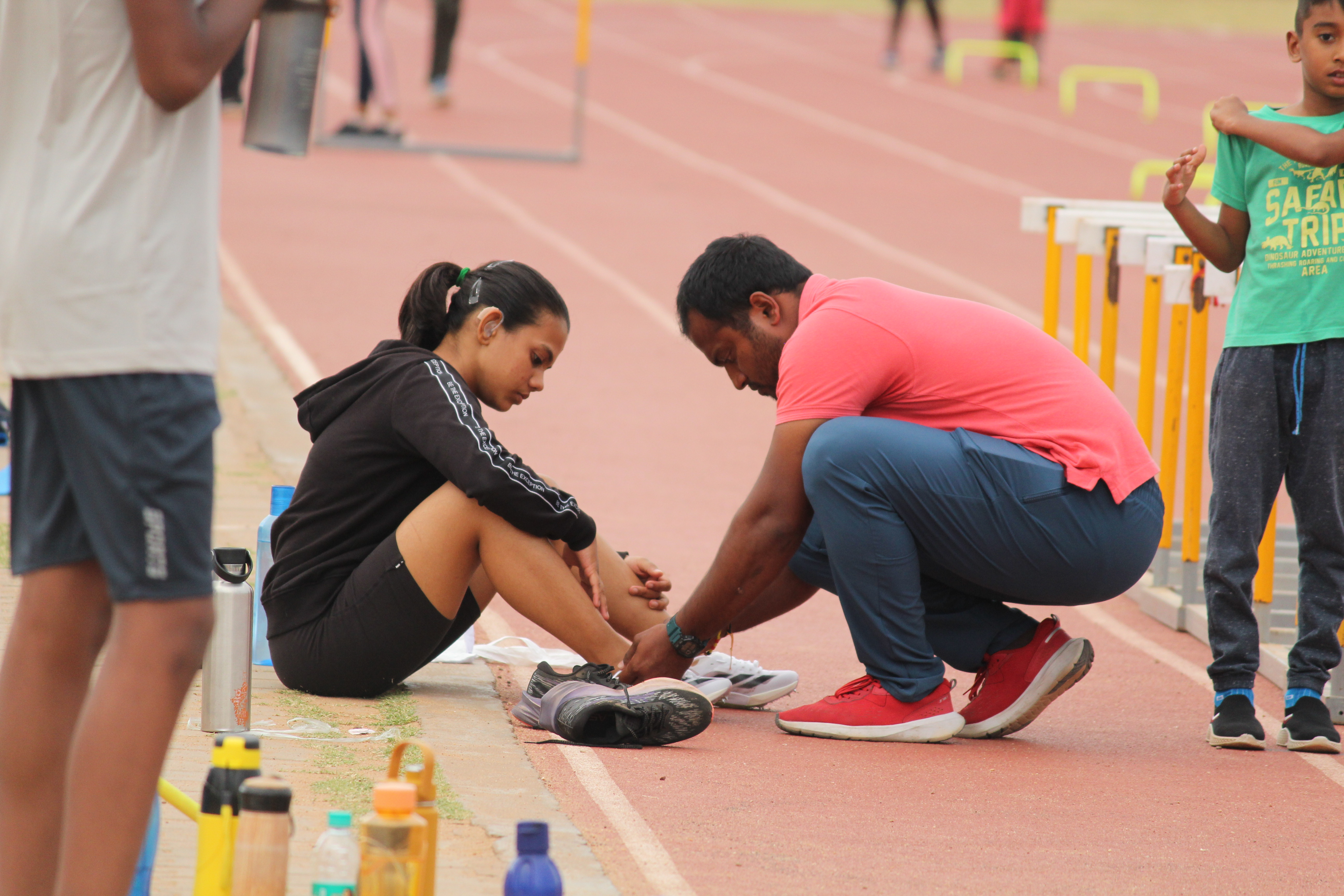 Rishitha and coach Radesh during preparation beside the track